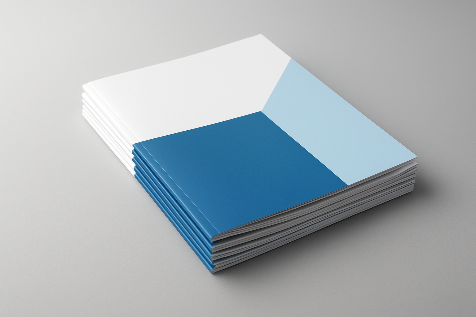 Stack of blue and white printed folders on a grey surface